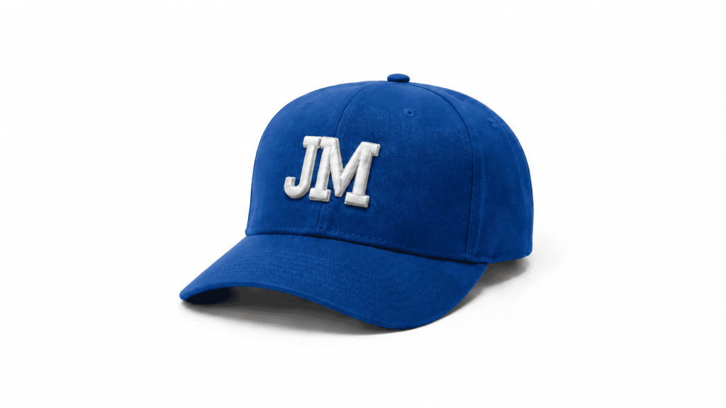 Custom royal blue baseball cap with white embroidered JM logo and curved brim