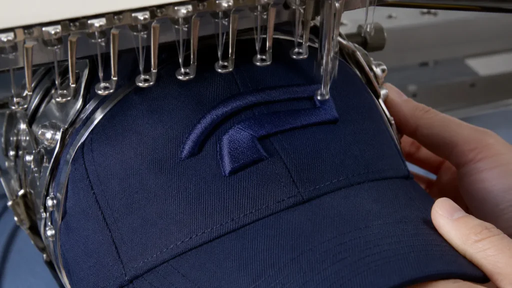 3D puff embroidery process showing foam under raised satin stitching. Illustrative image—replace with verified JIUMU photography when available.