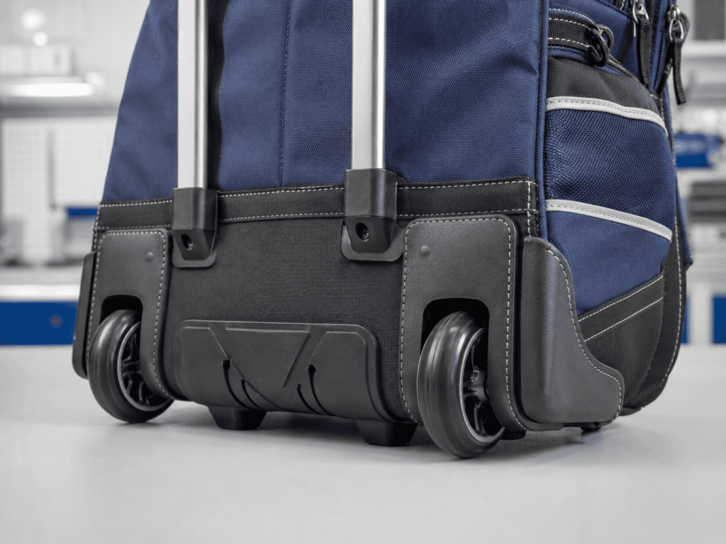 Reinforced wheel housing, molded base and telescopic handle construction of a rolling school backpack